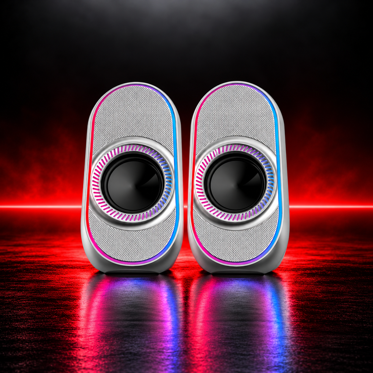 Silver portable speaker pair on a dark red-lit stage